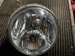 Harley Davidson Headlight With Mounting Bracket 67700204. Fixed Price $60.00.