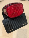 Harley Davidson Dyna License Plate Mounting Bracket 59979-99 W/lens. Fixed Price $38.79.