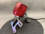 1970S Oem Honda CB125 Rear Tail Brake Light W/ Plate Mount Bracket. Fixed Price $199.00.